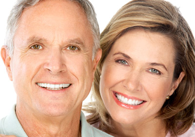A middle-aged man and woman smiling with good teeth