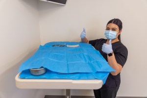 Image of a staff member with surgical equipment